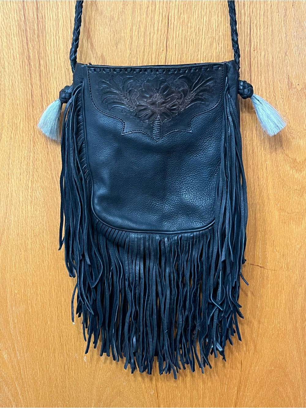 Black Fringed Leather Crossbody Bag with Embossed Floral Detail